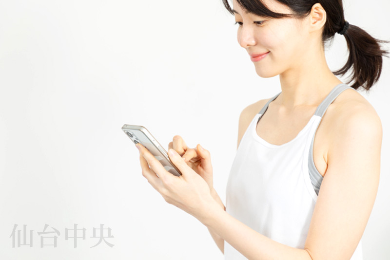 目元の若返りをスマホで検索する女性